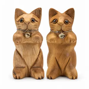 Two raised-paw wooden cats