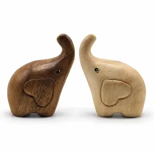 Two raised-trunk wooden elephants